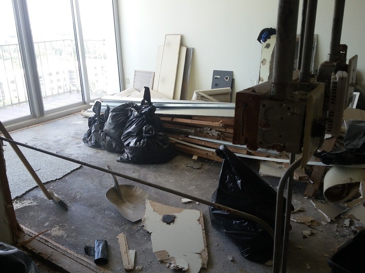 A room with a lot of trash bags on the floor