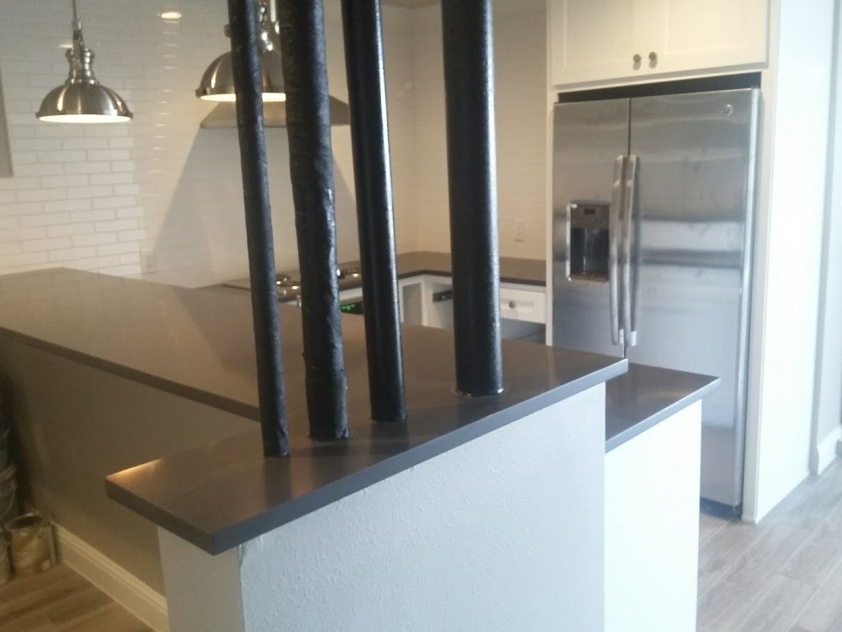 A kitchen with stainless steel appliances including a refrigerator