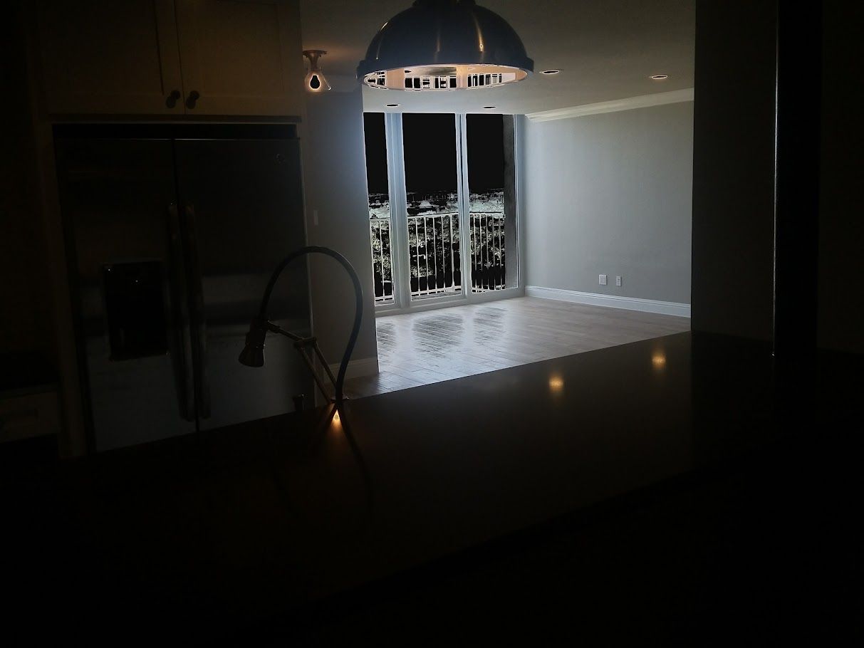 A dark room with a light hanging from the ceiling