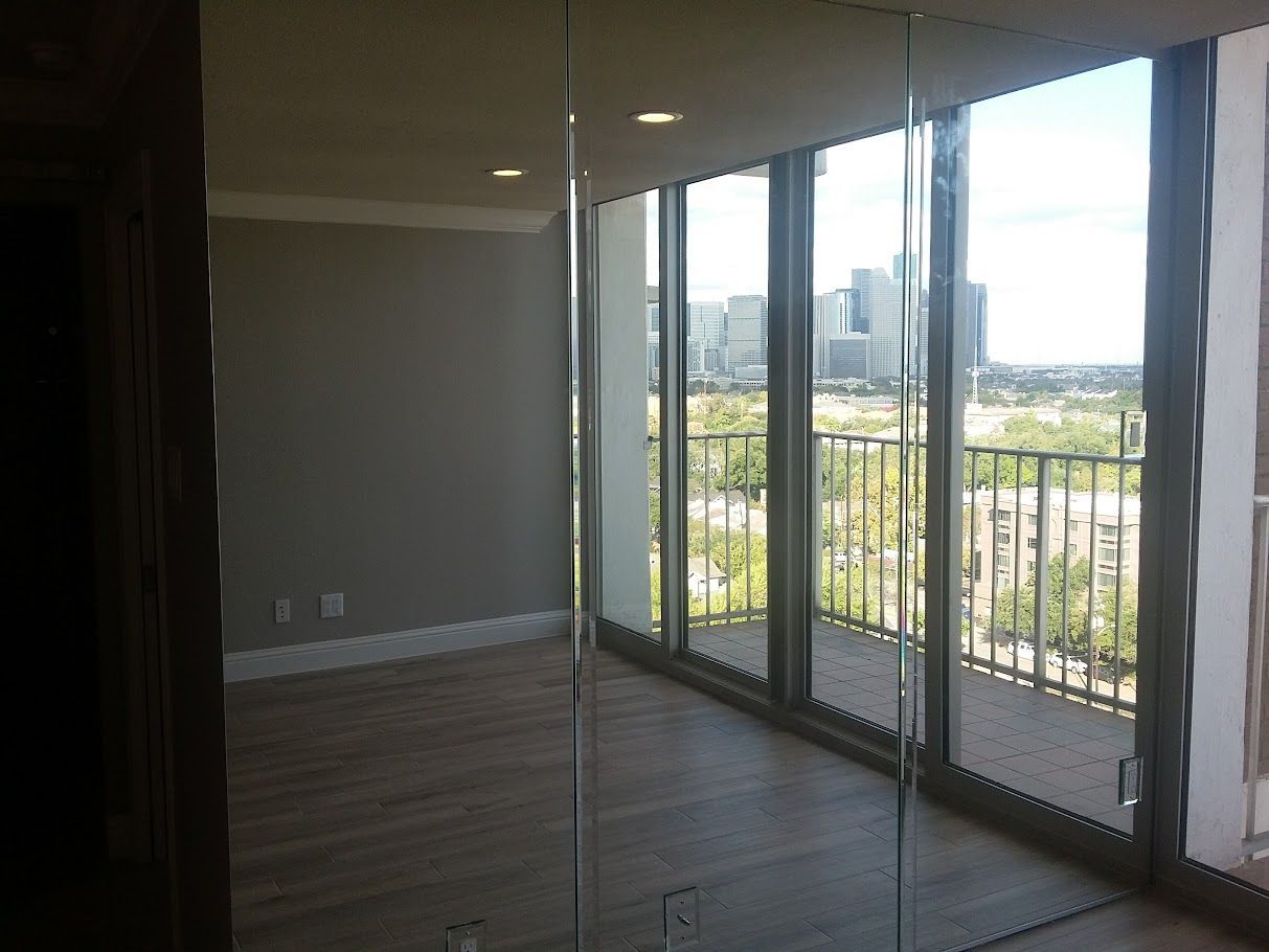 A room with a lot of windows and a balcony