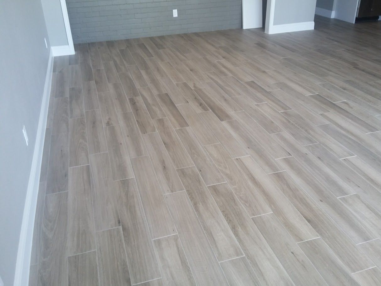 A living room with a wooden floor and a gray wall.