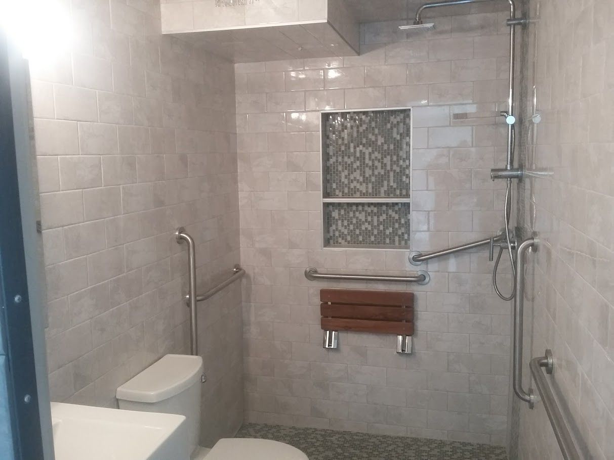 A bathroom with a toilet and a walk in shower