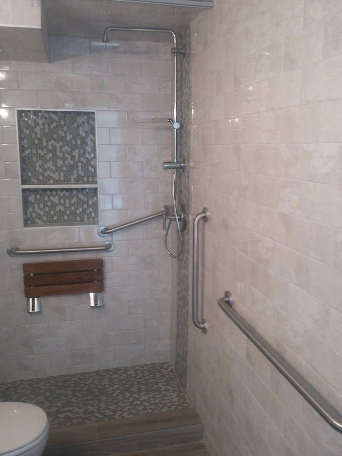A bathroom with a walk in shower and a toilet.