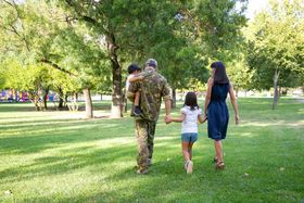 back-view-happy-family-walking-together-meadow-park-father-wearing-camouflage-uniform-holding-son-enjoying-weekend-with-wife-kids-family-reunion-returning-