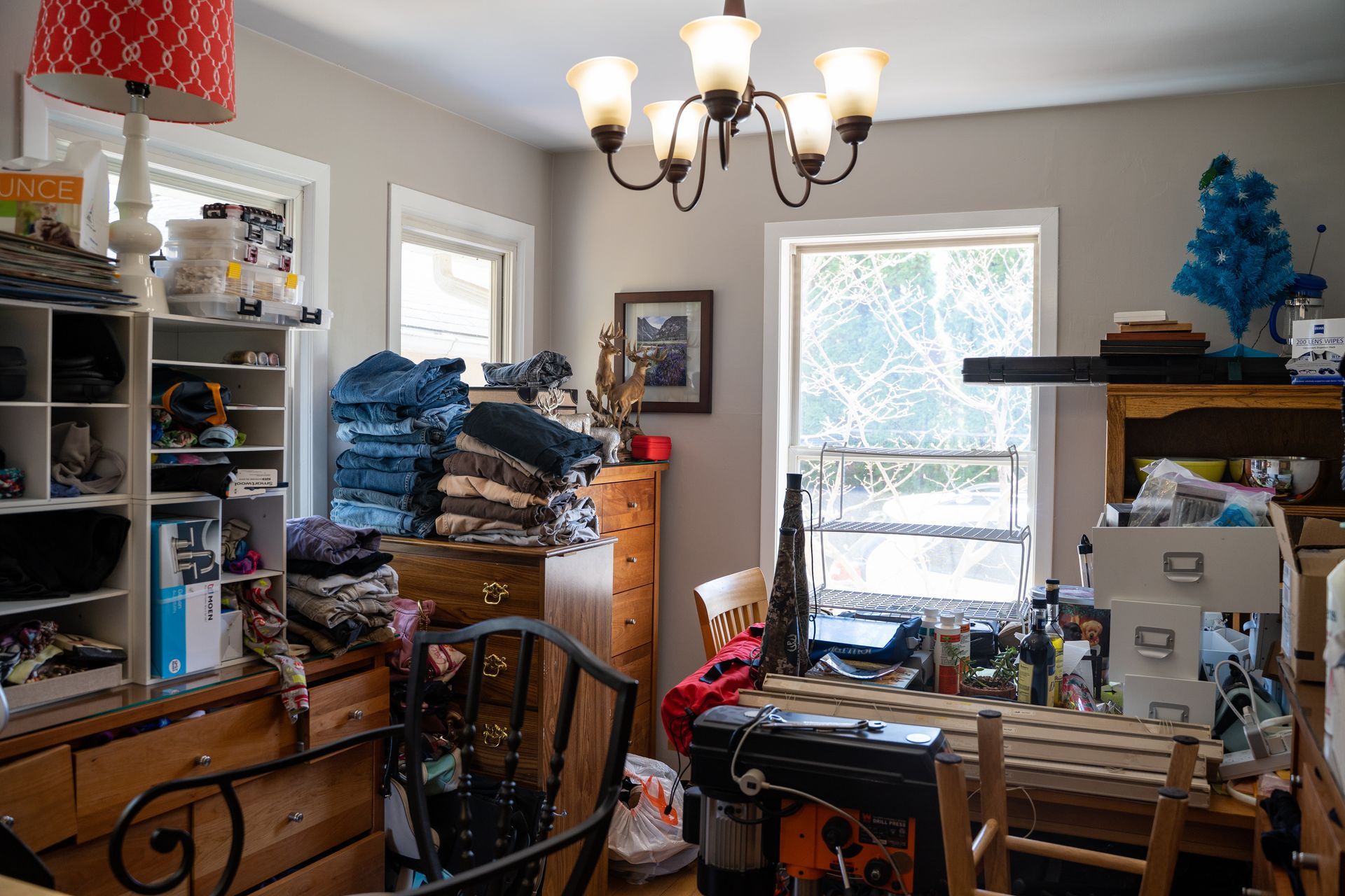 a cluttered room with a lamp that says ounce on it