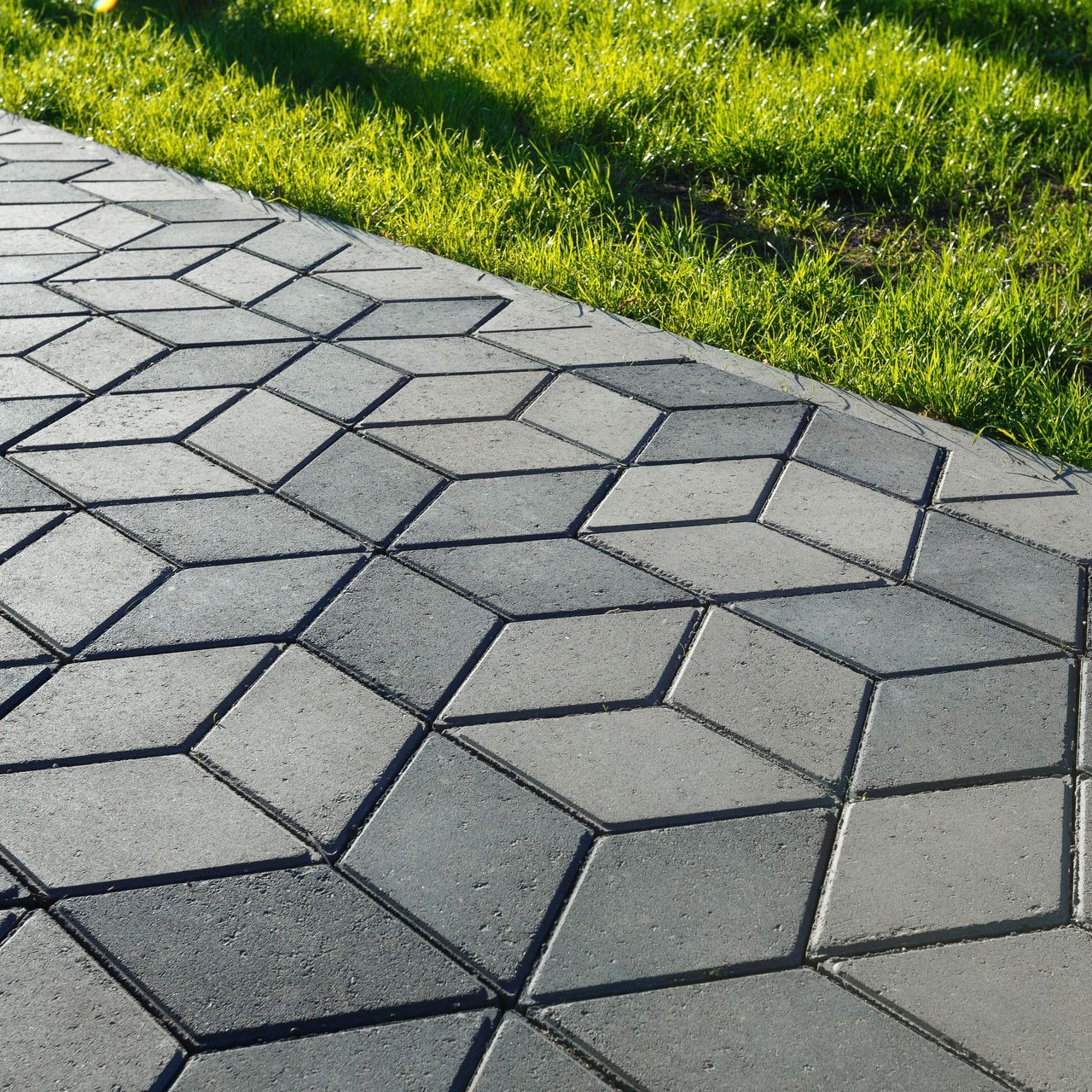 a brick walkway with a geometric pattern on it