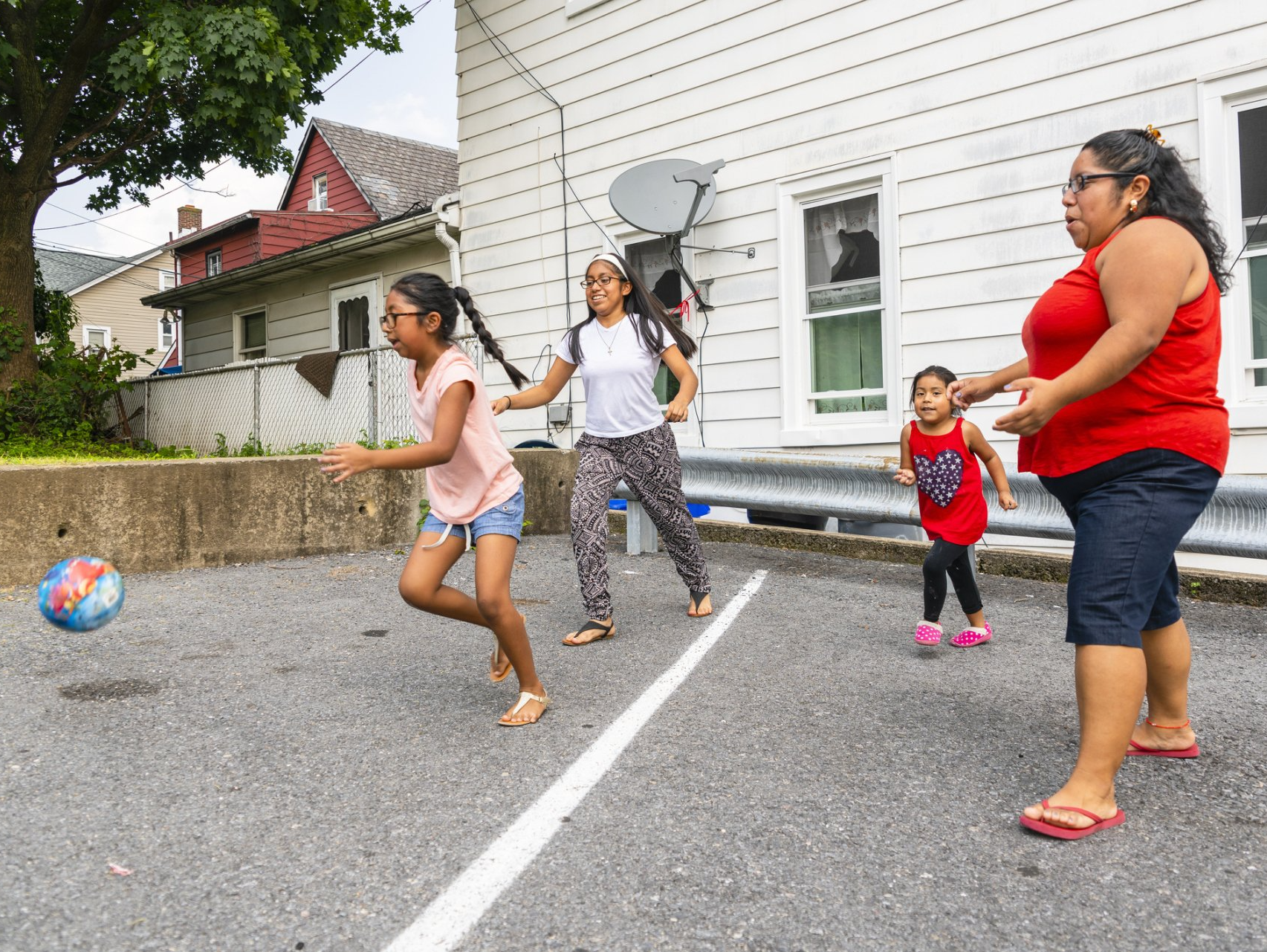 Family playing soccer outside