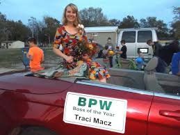 Woman in floral dress on convertible, 