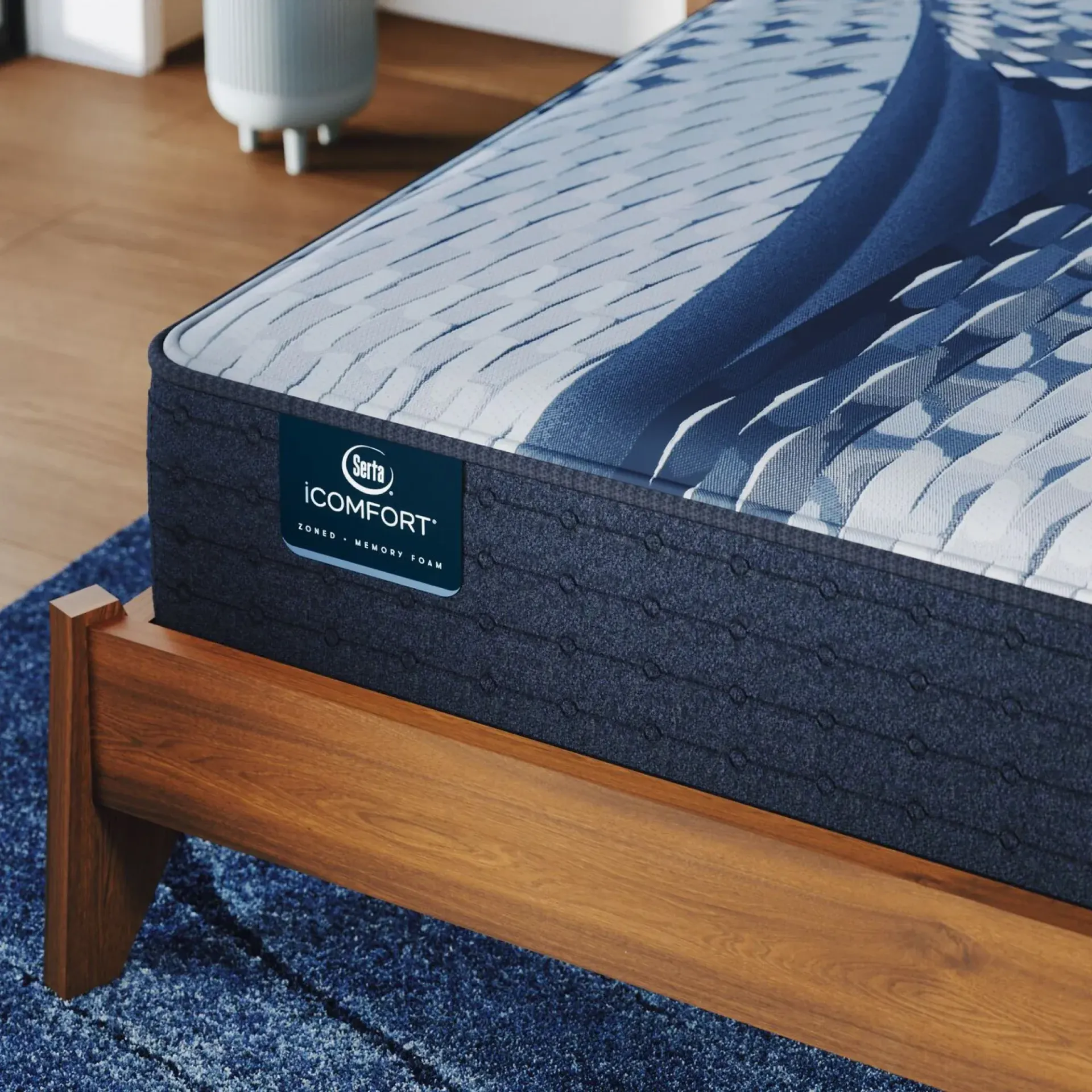 A comfort mattress is sitting on top of a wooden bed frame.