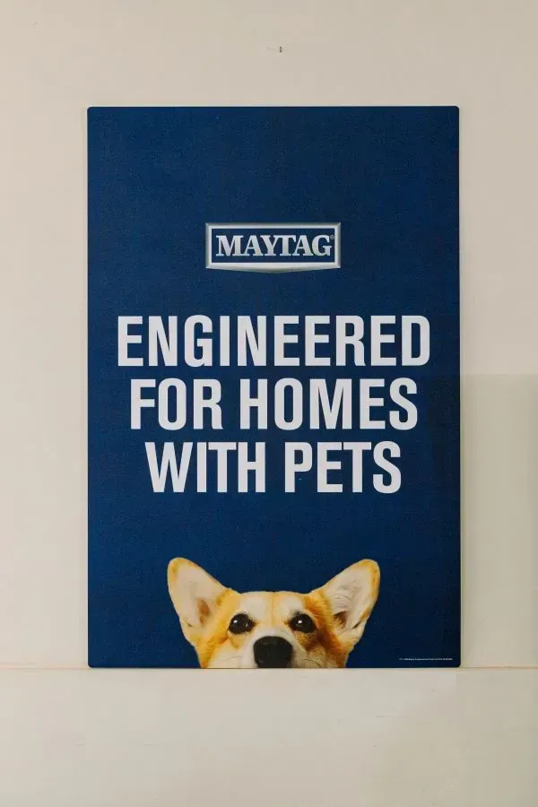 A white washing machine with a black top on a white background.