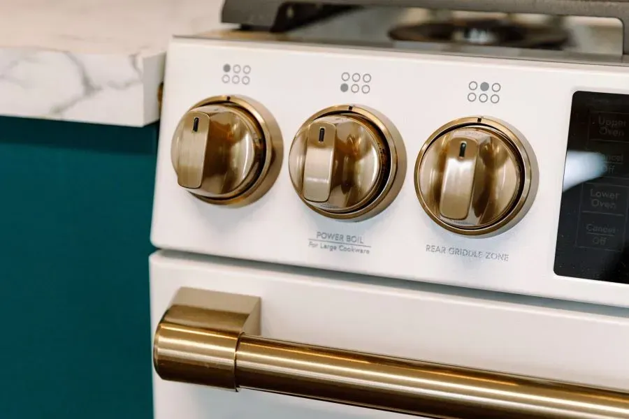 A close up of a stove with three buttons on it.