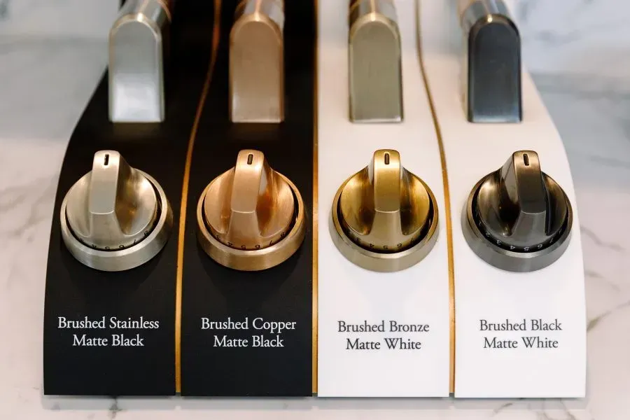 A display of four different types of stove knobs.