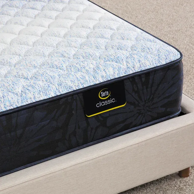 A serta classic mattress is sitting on a bed