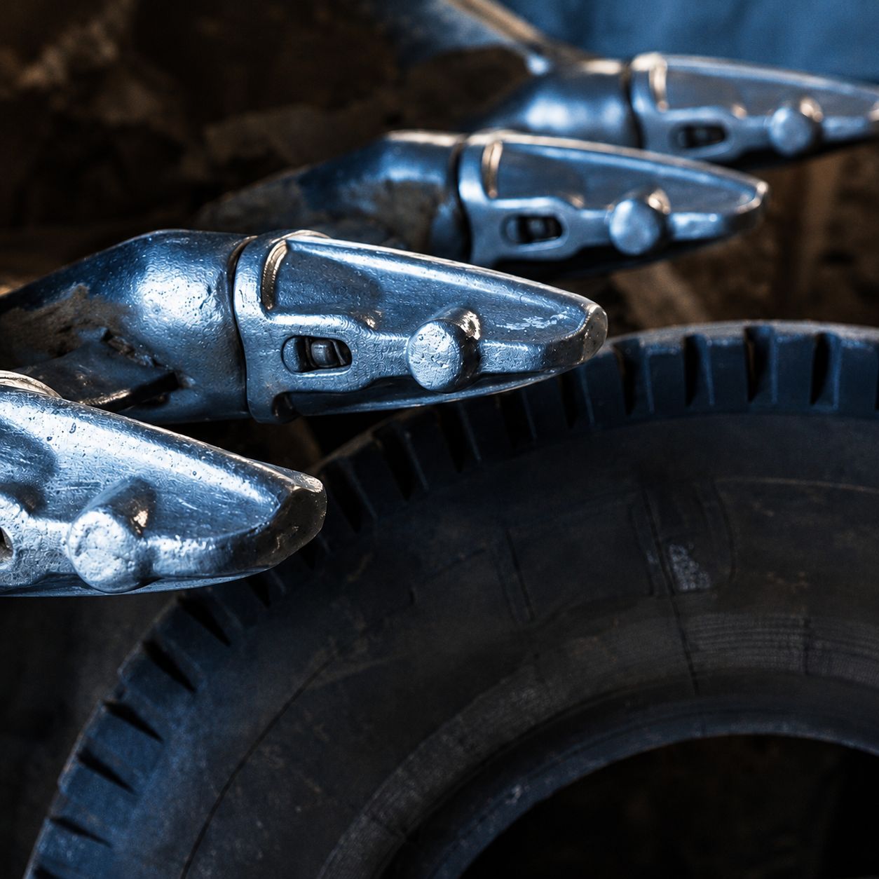 Metallic robotic snake heads surrounding a black tire