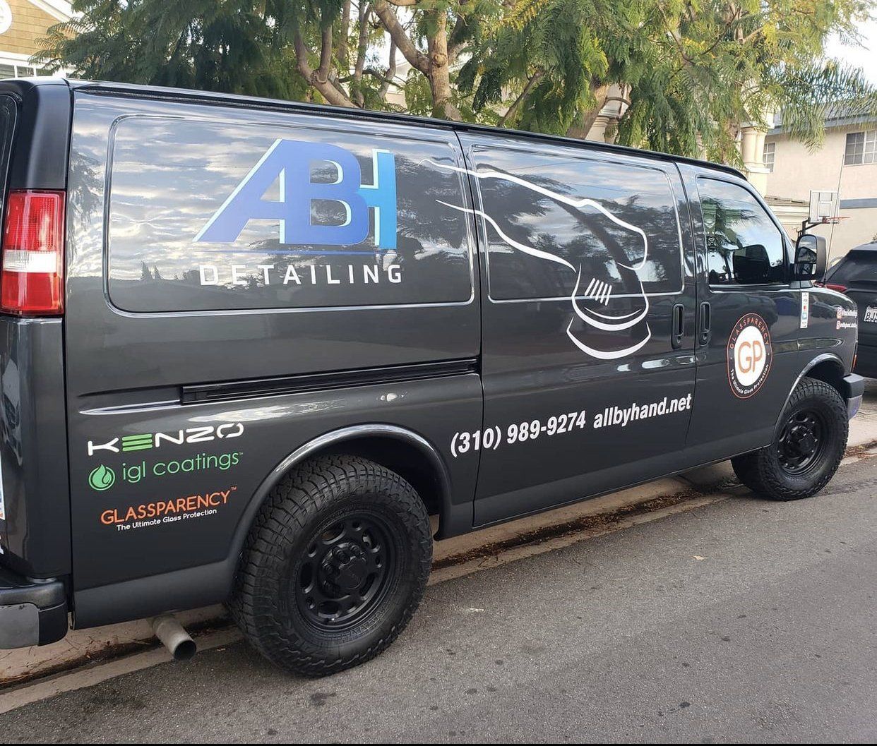 a black van with the word detailing on it