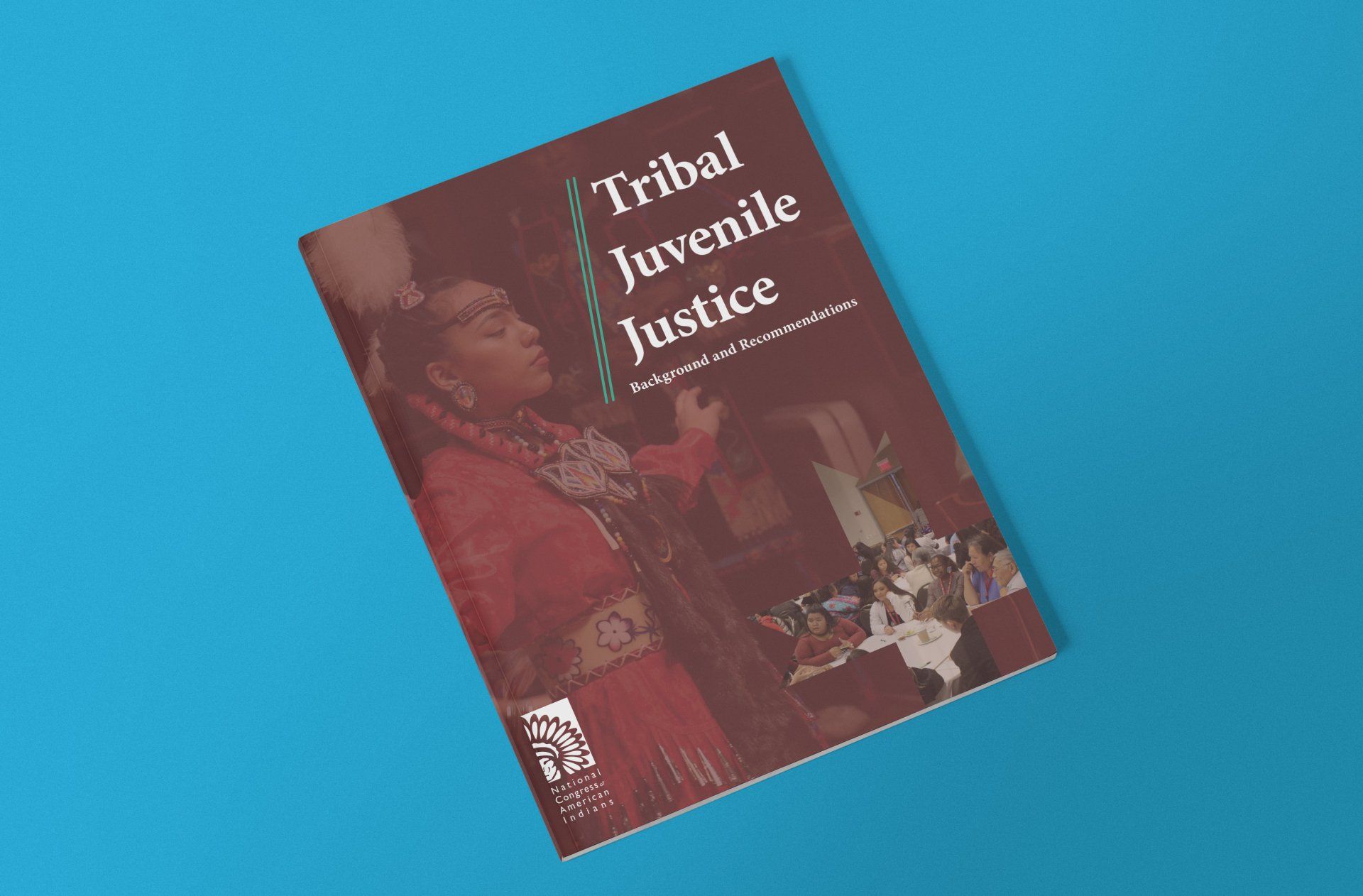 a book titled tribal juvenile justice is sitting on a blue surface .