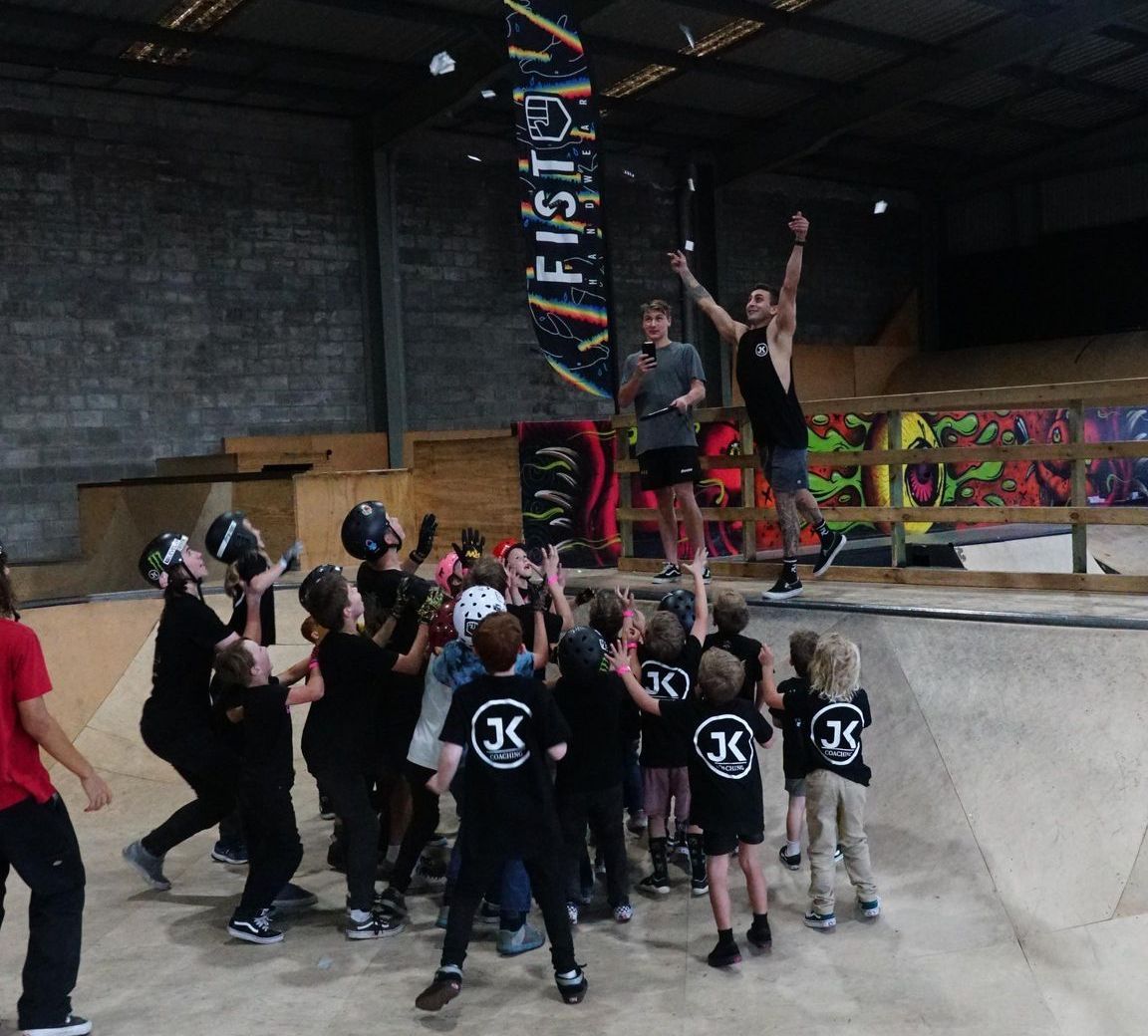 A group of people are standing in front of a sign that says fistpy