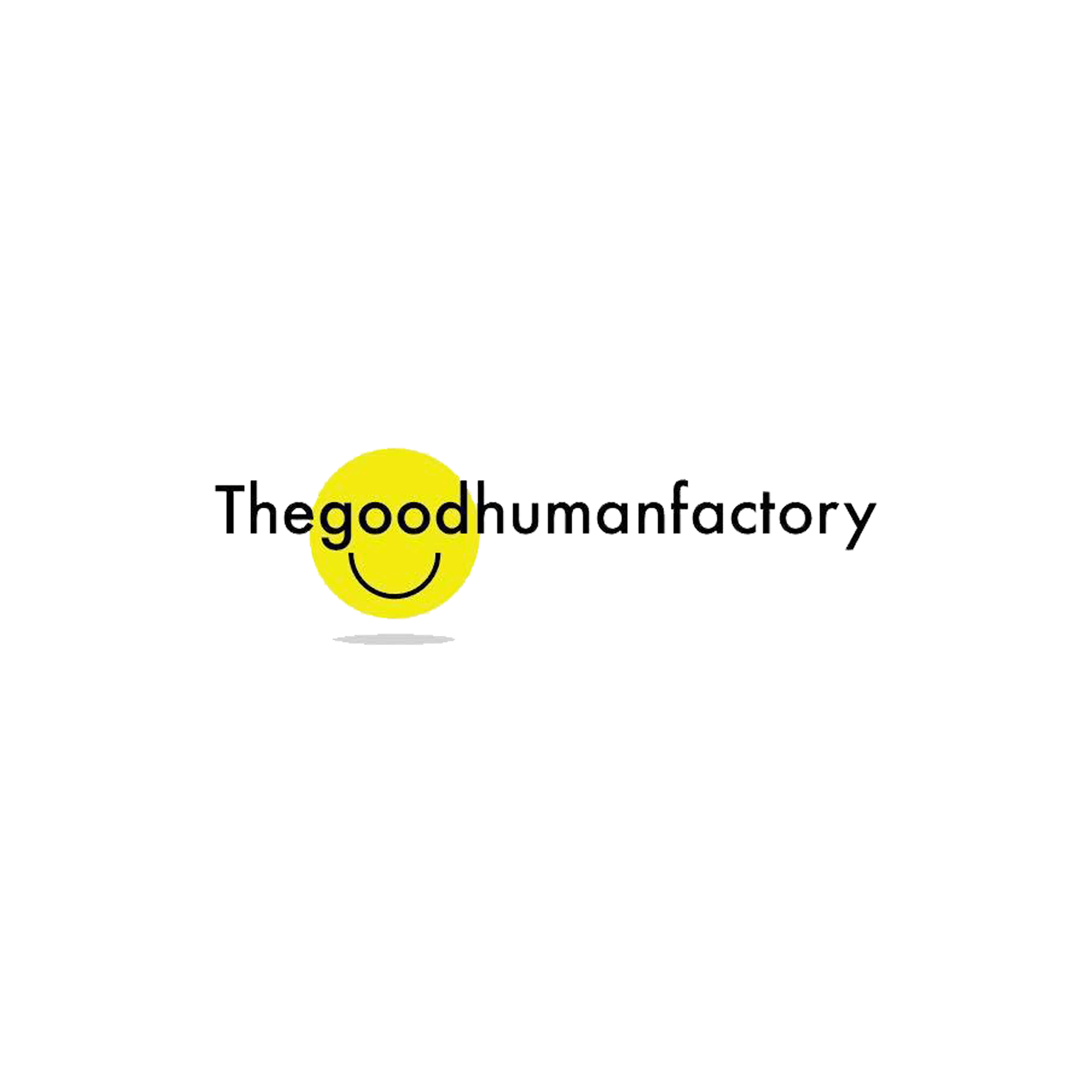 The logo for the good human factory is a yellow circle with a smile on it.