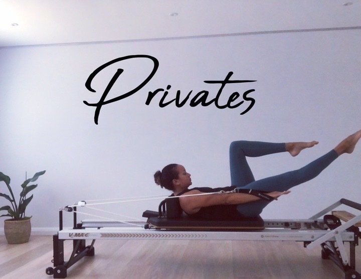 A woman is doing pilates in front of a wall that says privates