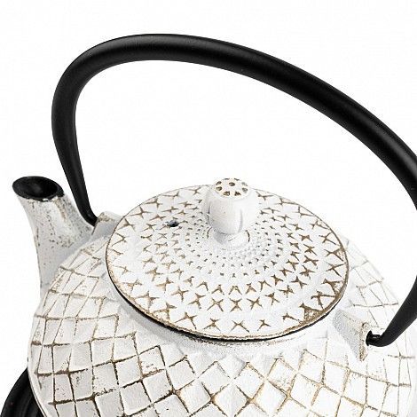 Tetera de hierro fundido blanca con asa y pomo de tapa negros.