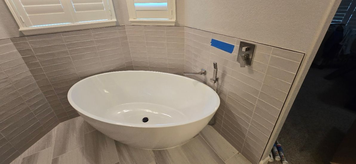 A bathroom sink with a faucet and tools on it.