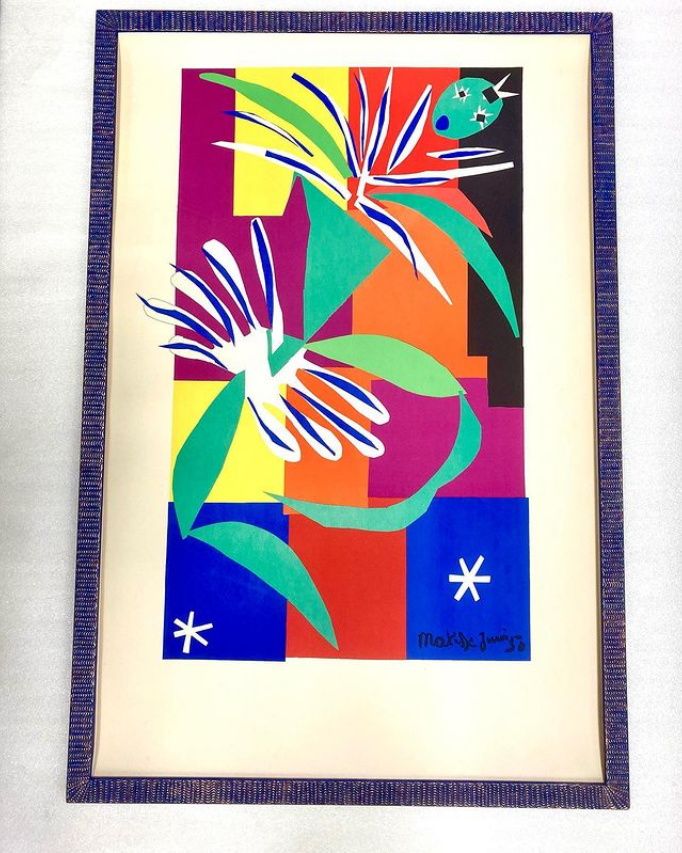 A framed painting of a bird and flowers by henri matisse
