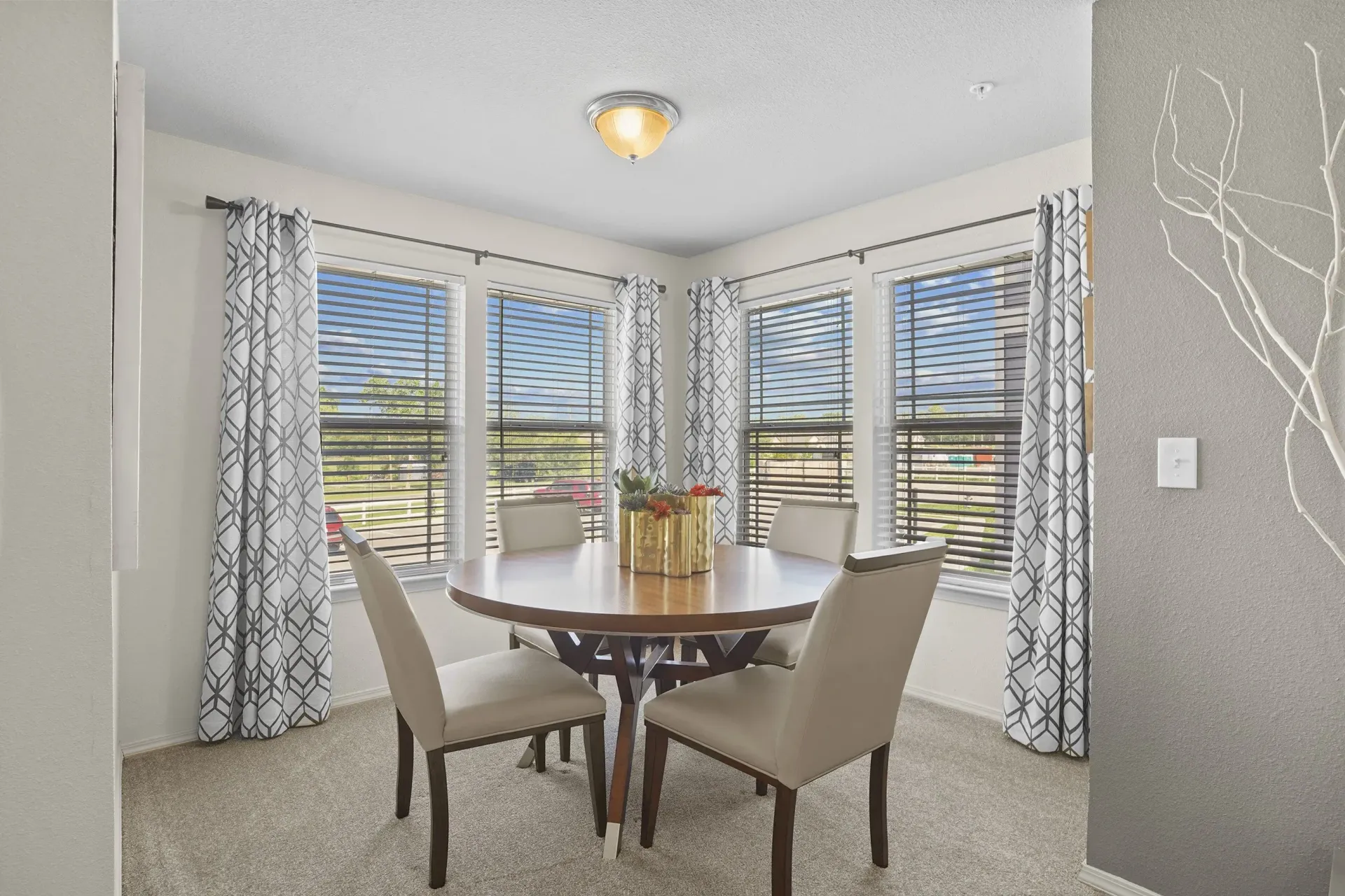 A dining room with a table and chairs.