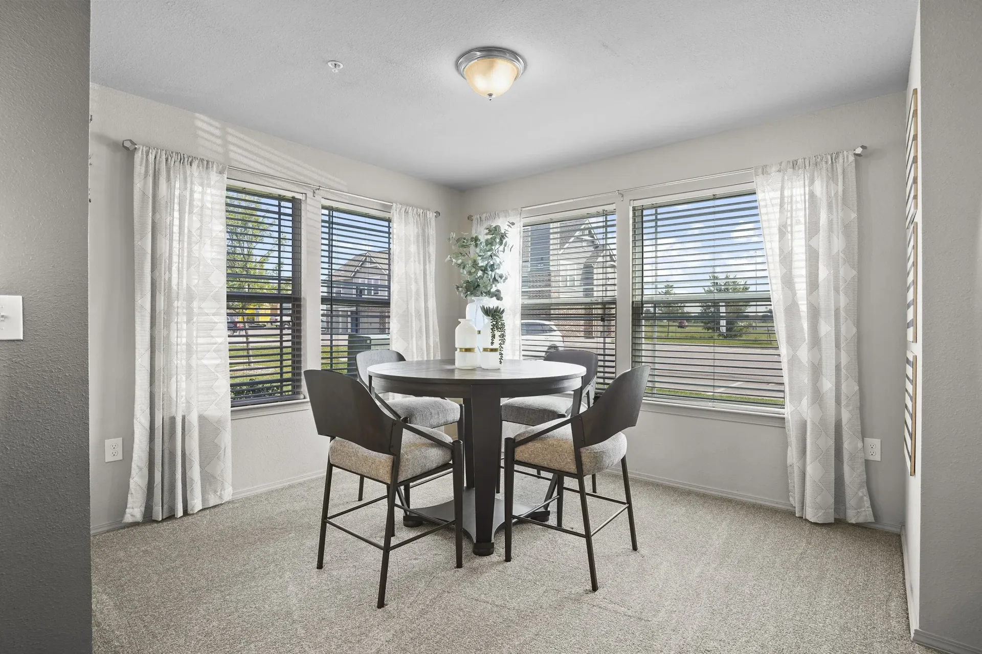 A dining room with a table and chairs.