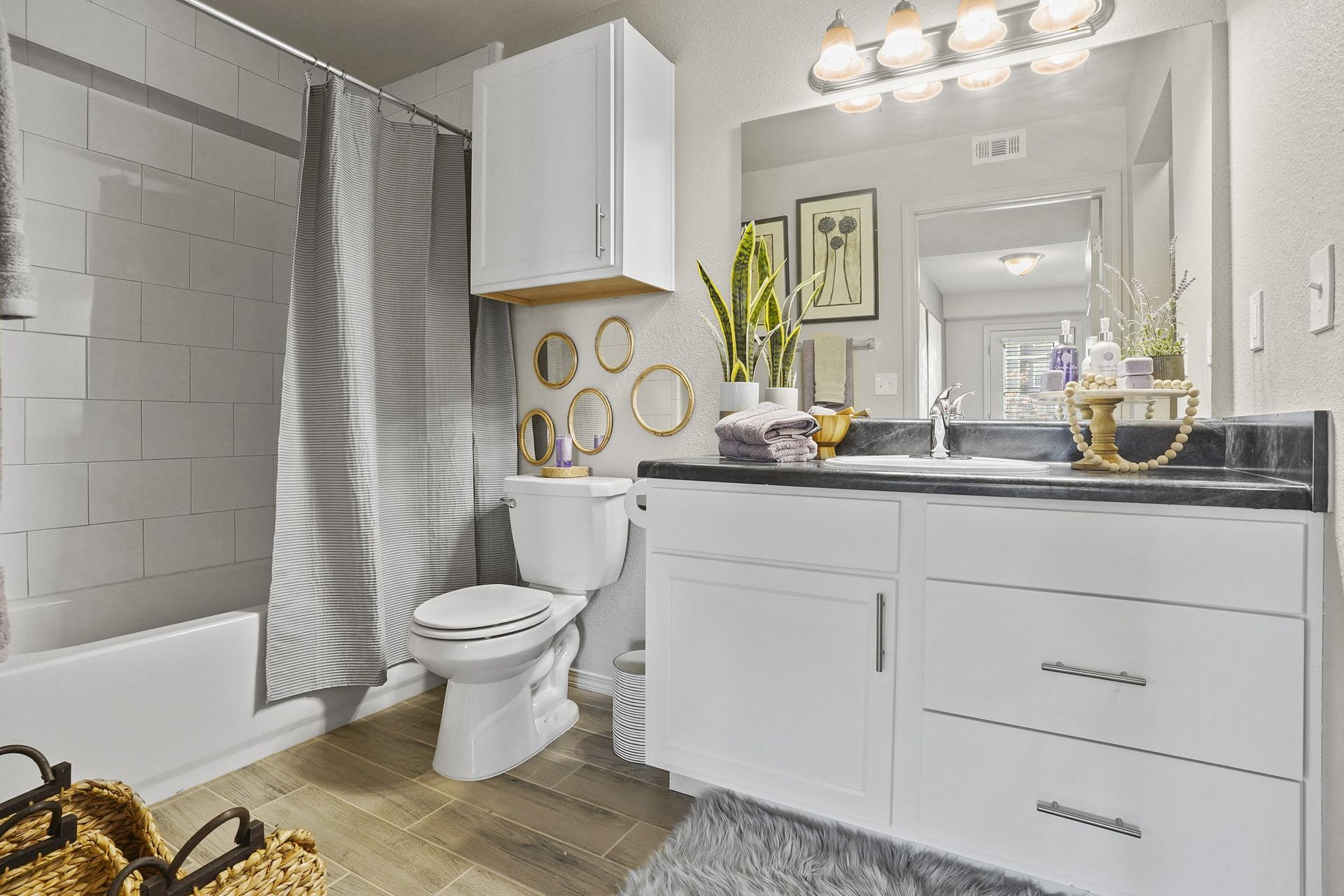 A white bathroom with a toilet, sink, and shower.