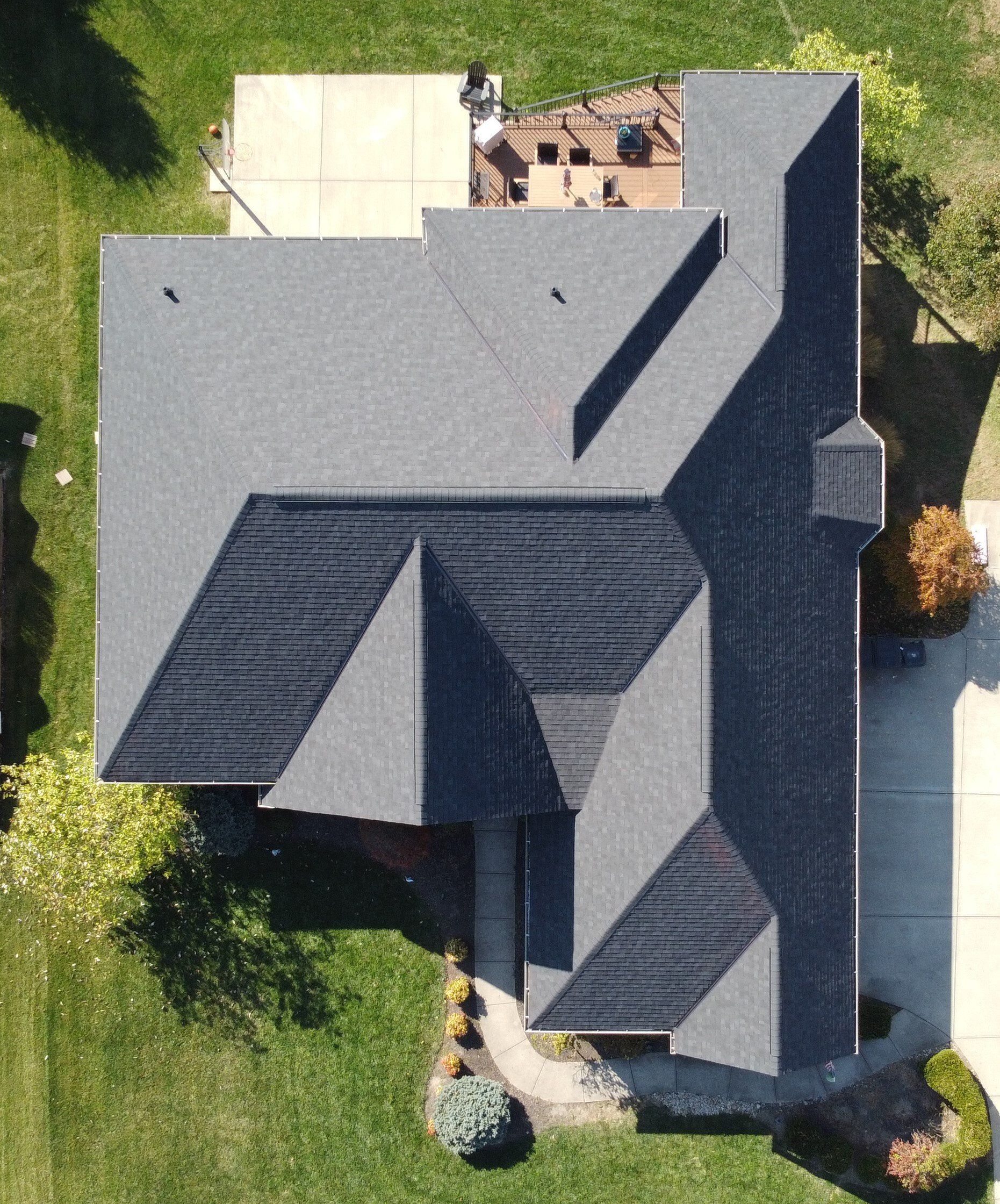 A picture of a slate shingled roof being repaired by Roofers Cincinnati