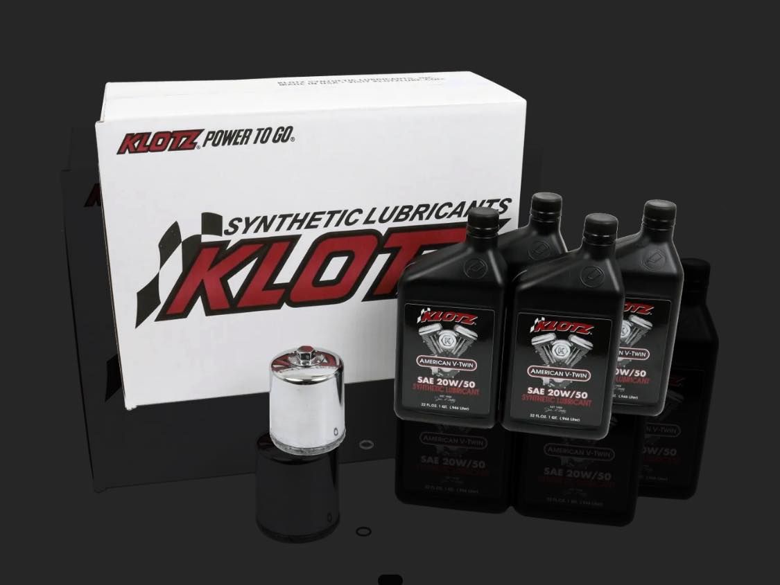 Klotz synthetic lubricants box and bottles with an oil filter against a dark background.