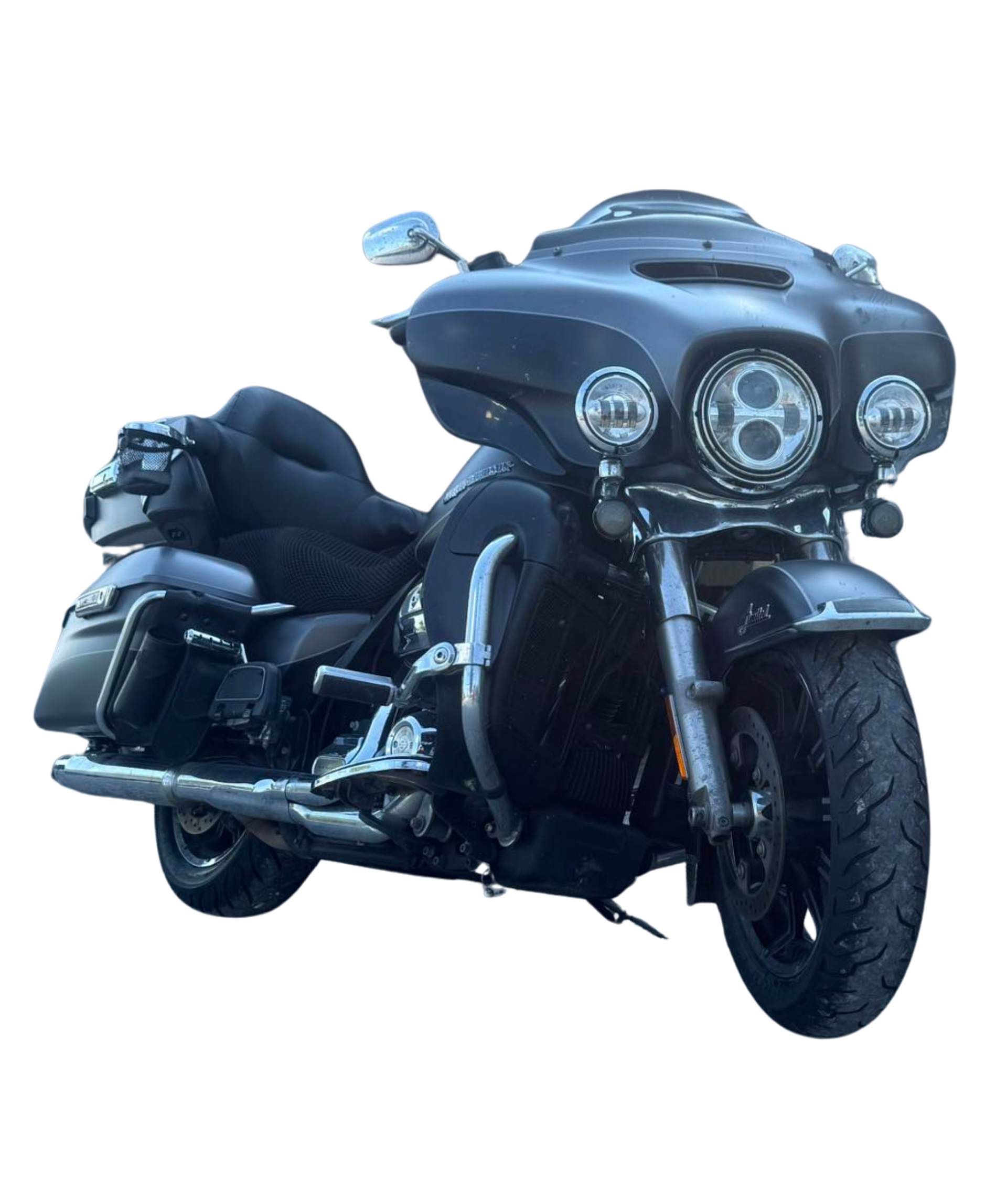 Black Harley-Davidson motorcycle with fairing, saddlebags, and tour pack, parked on pavement.