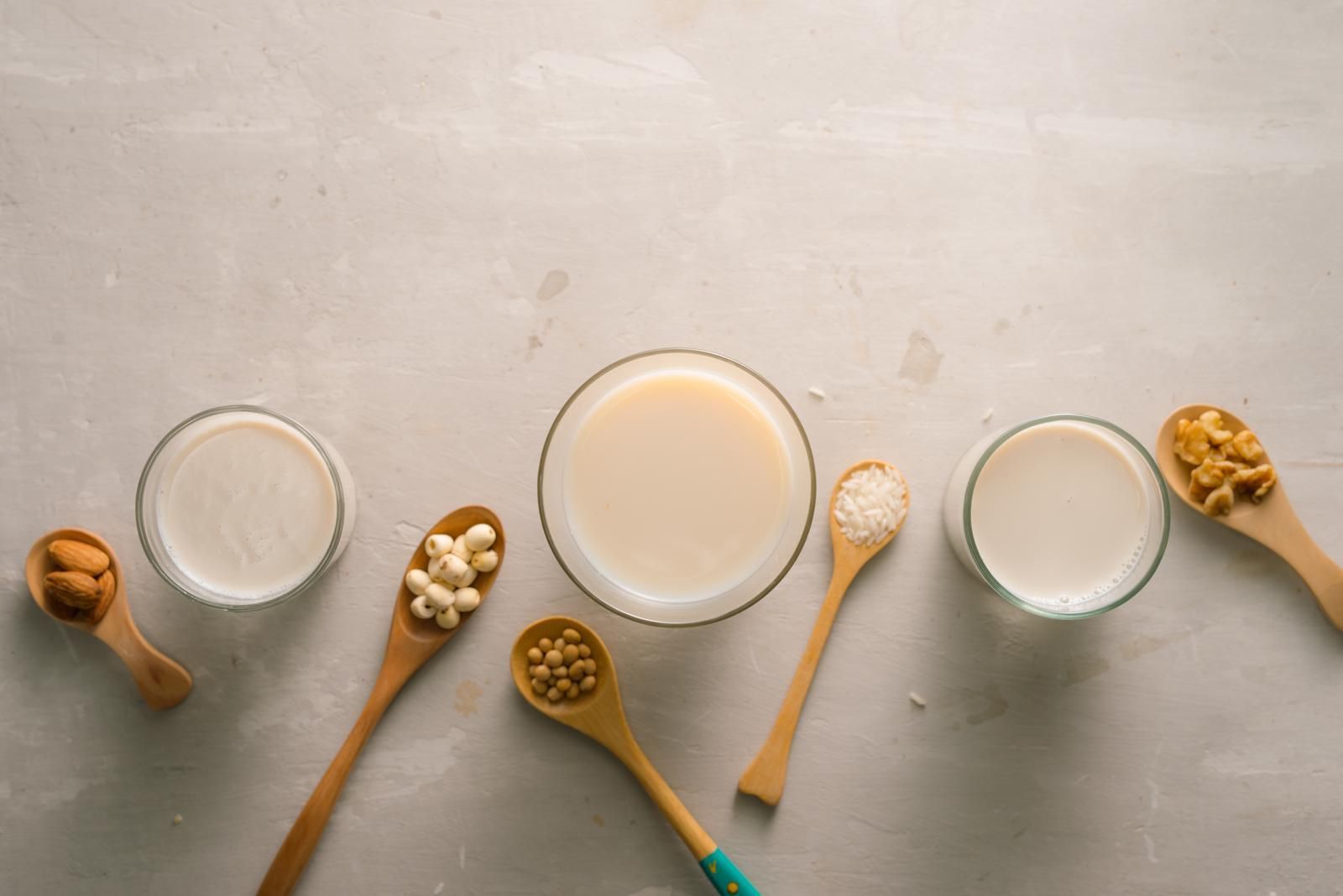 glasses-of-milk-with-nuts-macadamia-almond-soy-rice-lotus-top-view