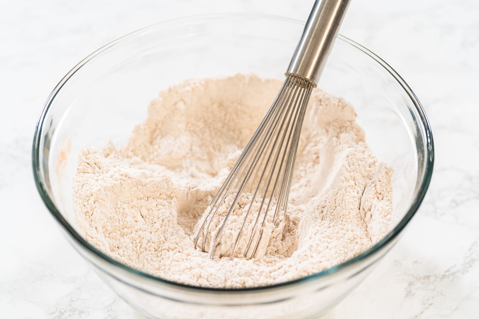 Top-down view of dry ingredients for Dough Perfect for Baking being whisked
