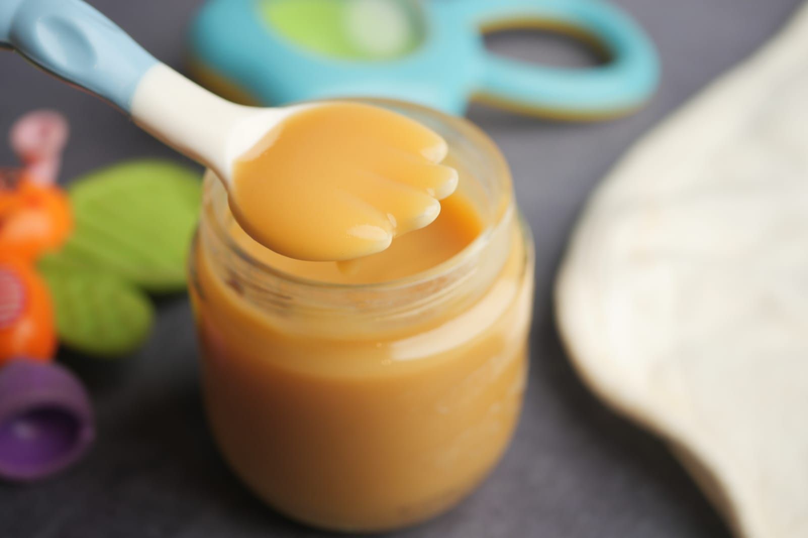 food jar with pureed baby food on a spork
