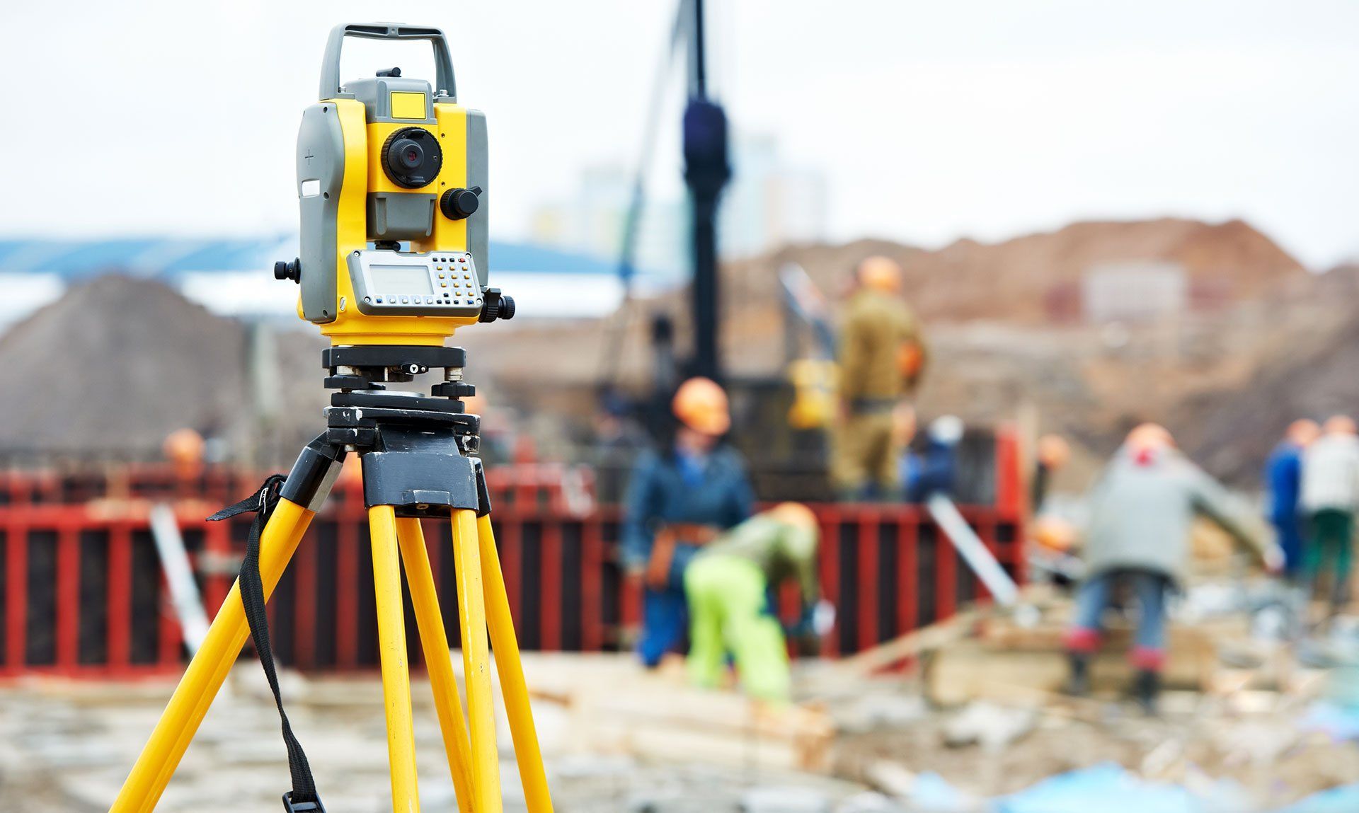 Land surveyor in Edmonton marking property boundaries using total station.