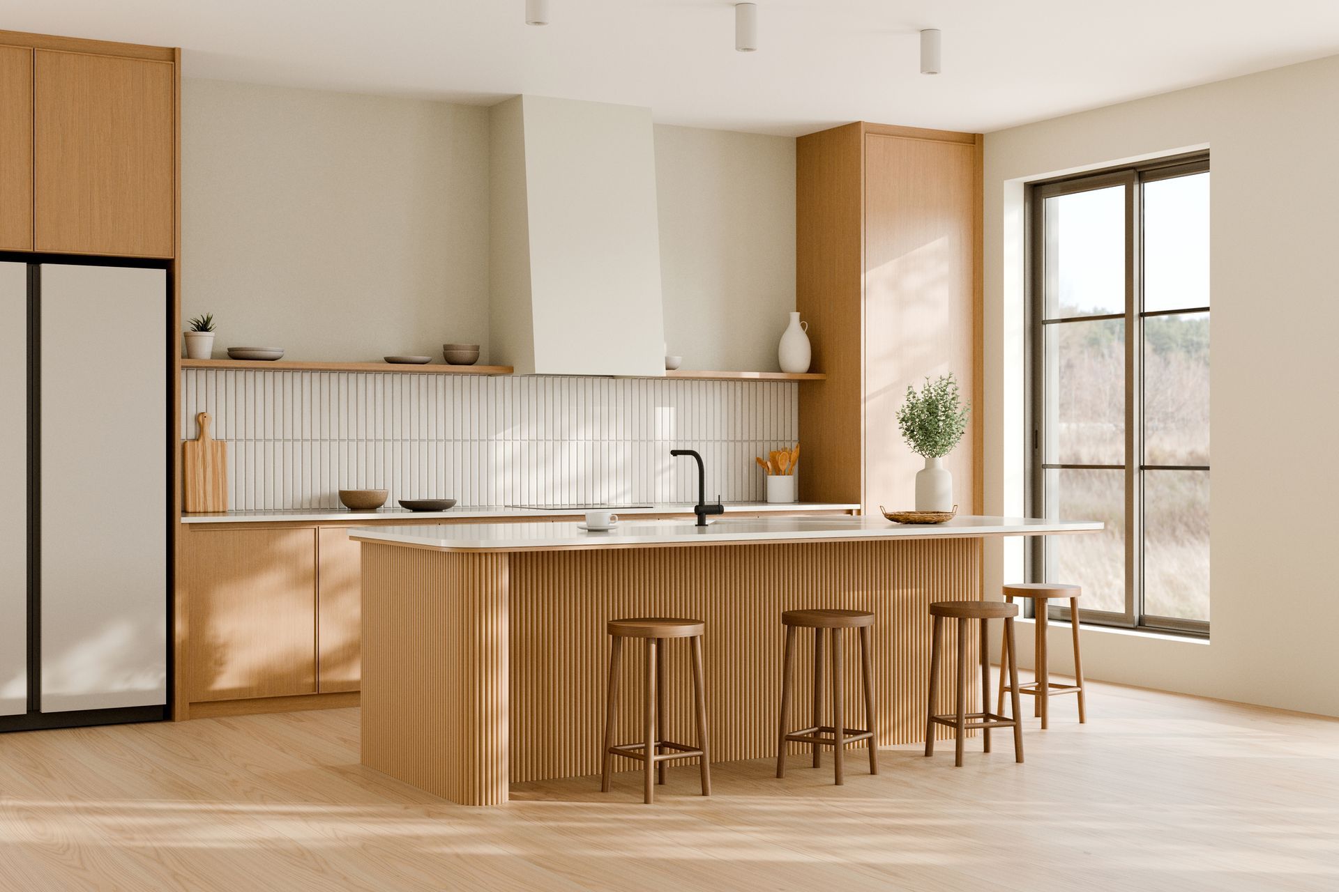 A kitchen with a large island , stools and a refrigerator.