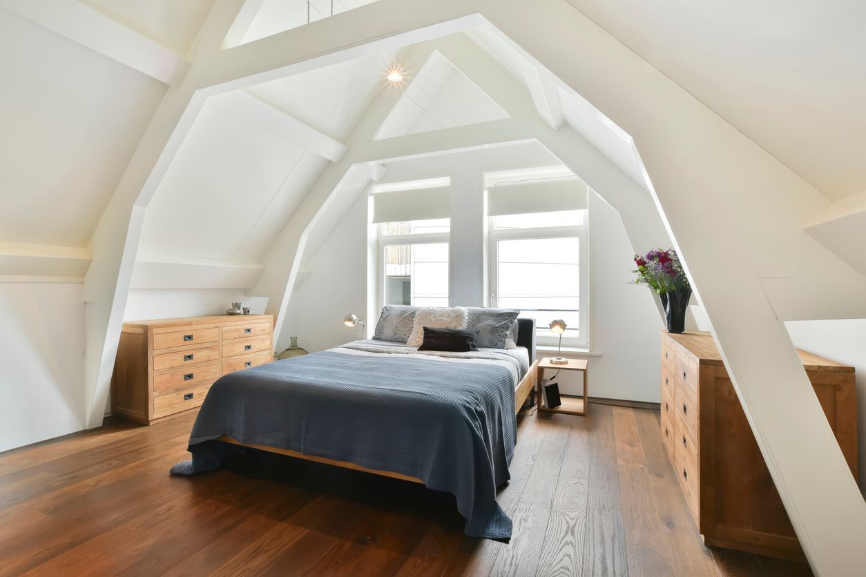 A bedroom with a bed , dresser , and window.