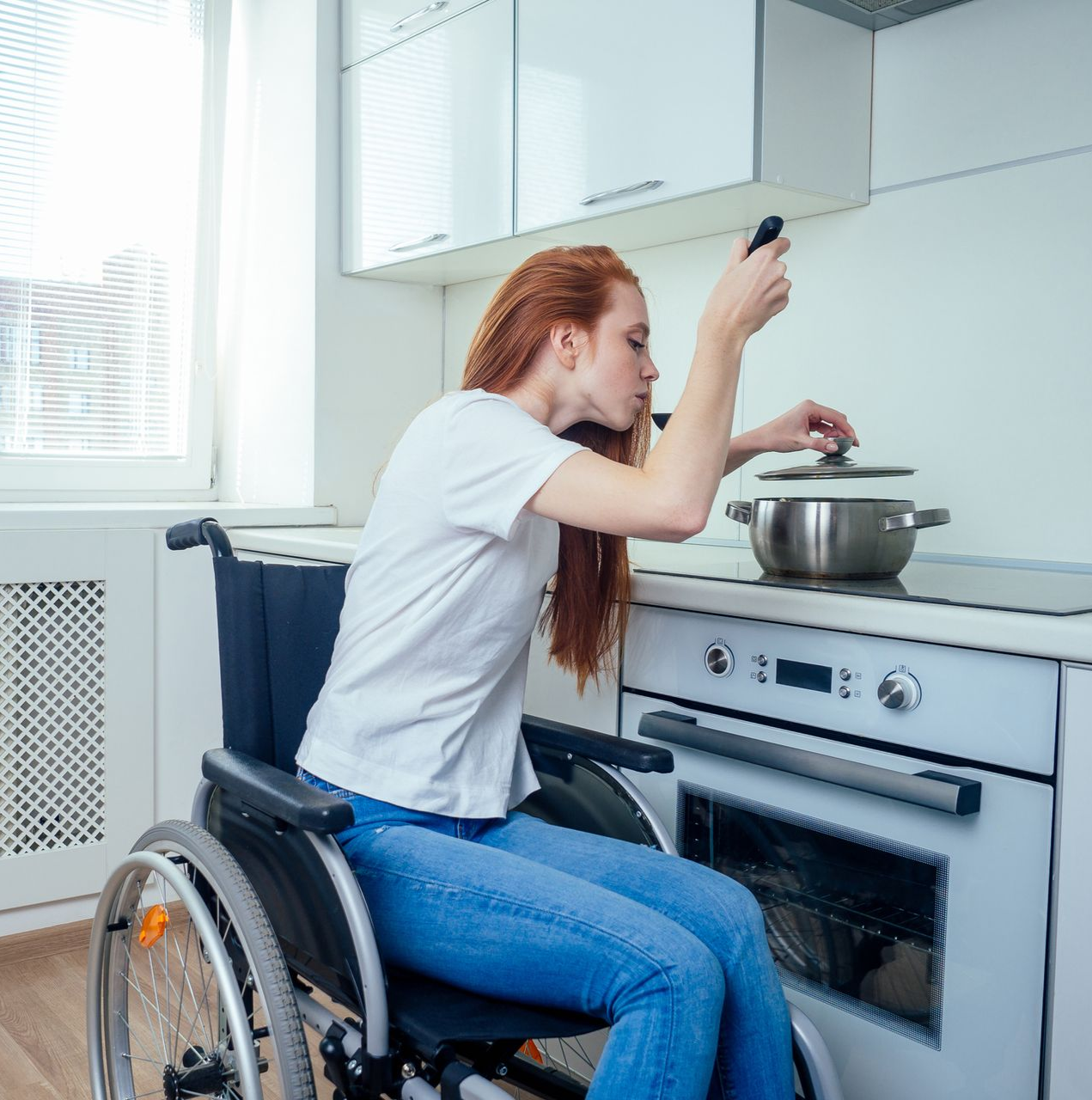 A bathroom with a tub , sink , mirror and shower.