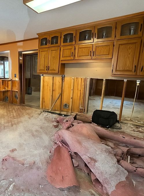 A bedroom with a bed , dresser , and window.
