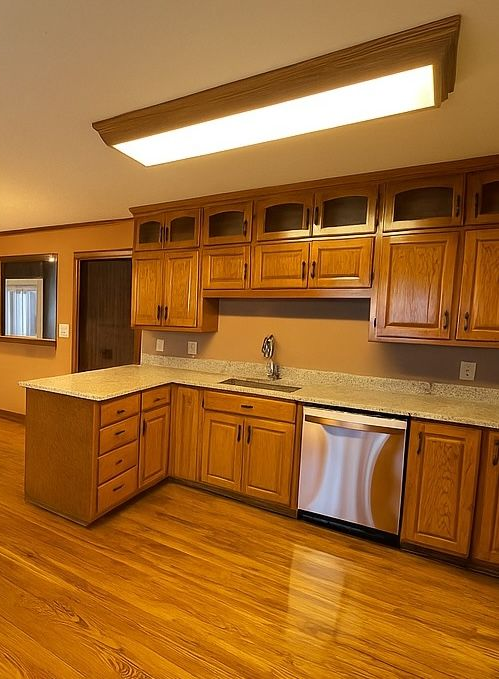 A bathroom with a tub , sink , mirror and shower.