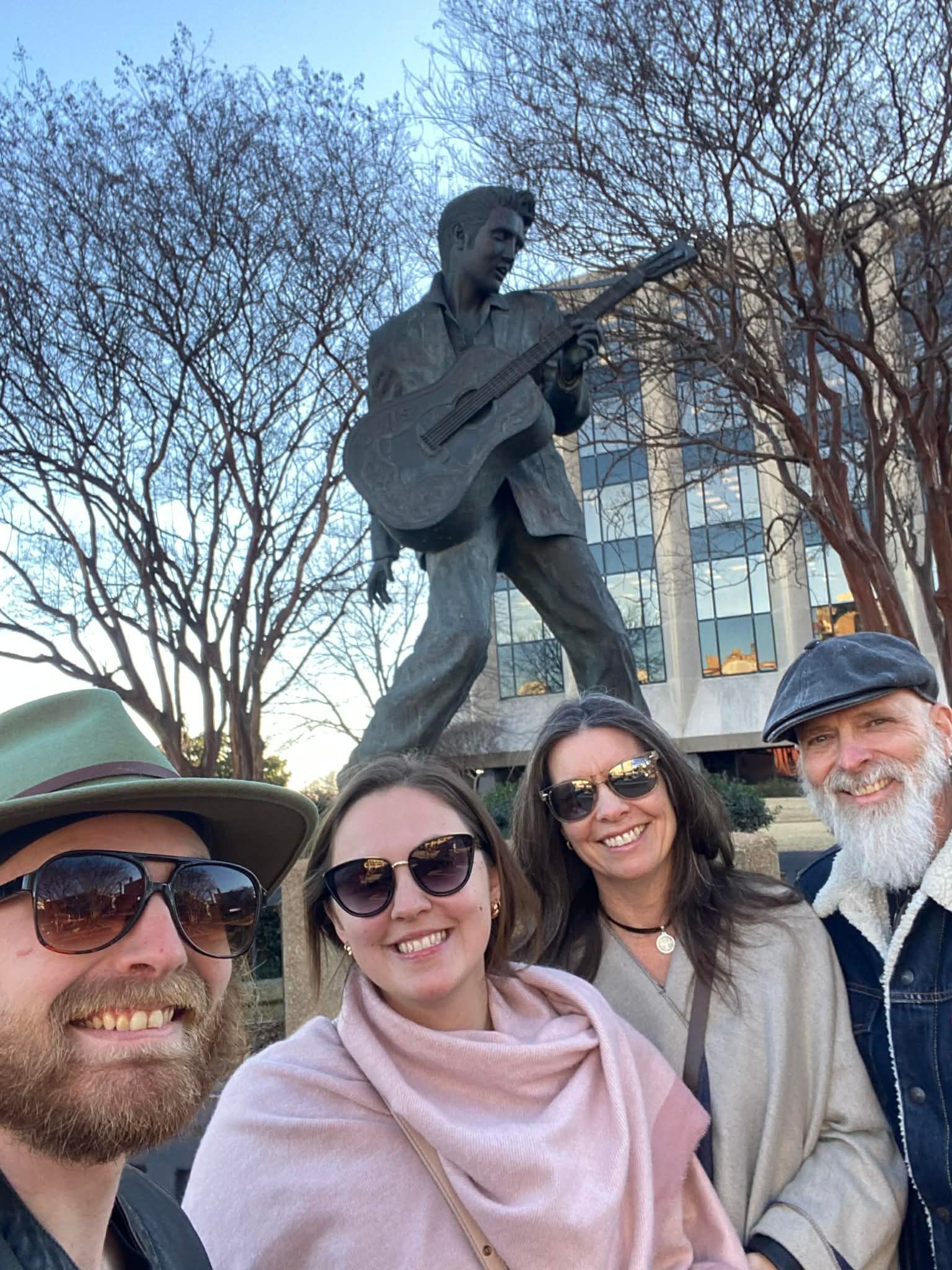 Father'n'Son and entourage posing in front of a statue of Elvis Presley