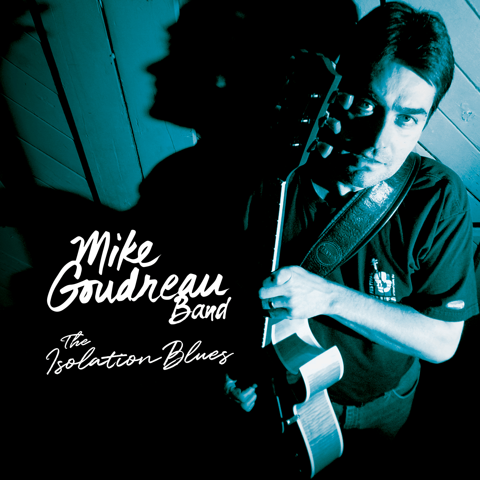 Album cover of Mike Goudreau Band's  The Isolation Blues contains a man holding a guitar
