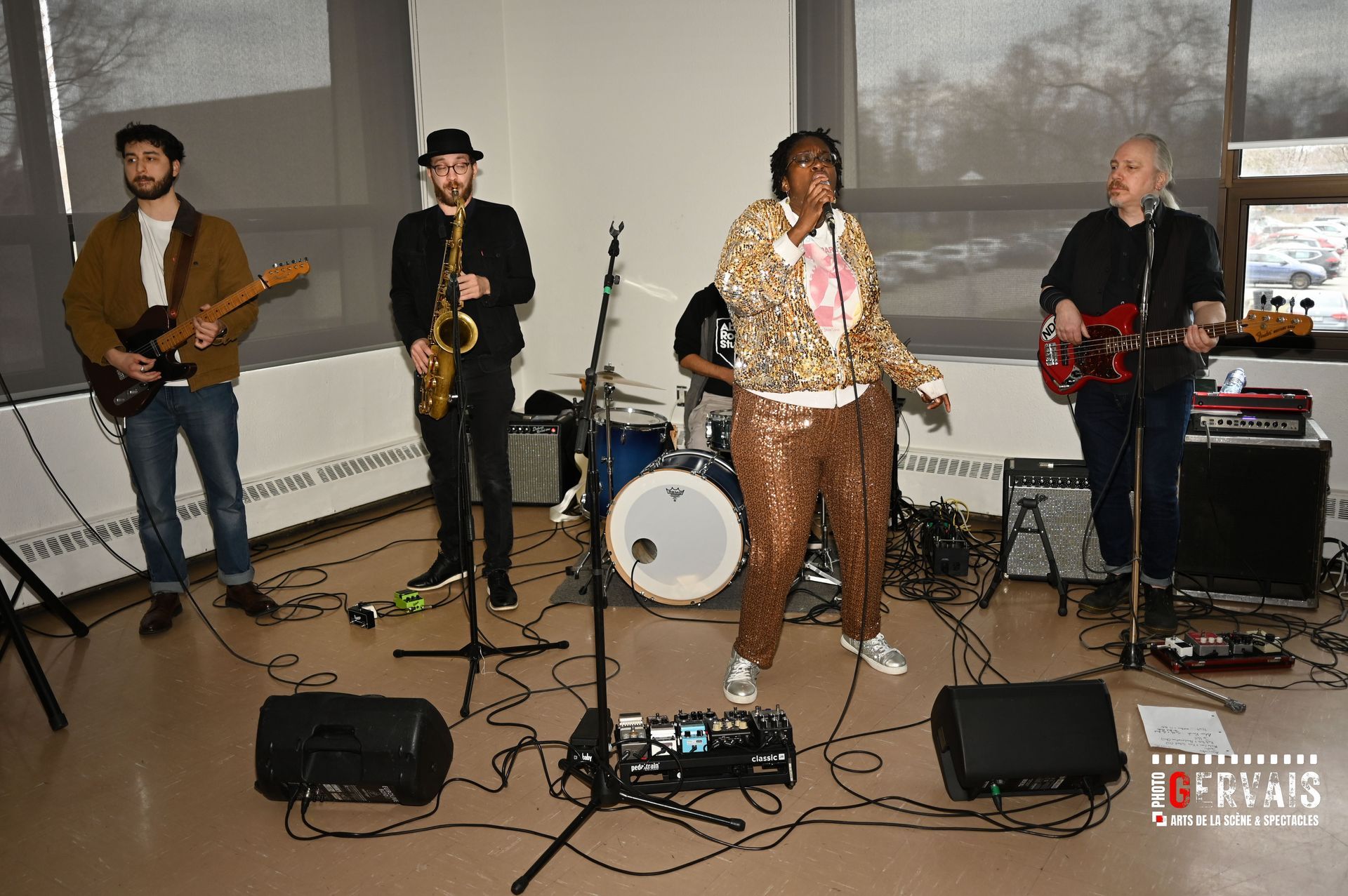 Guitar player, sax player guitar player with a singer in sparkly clothing