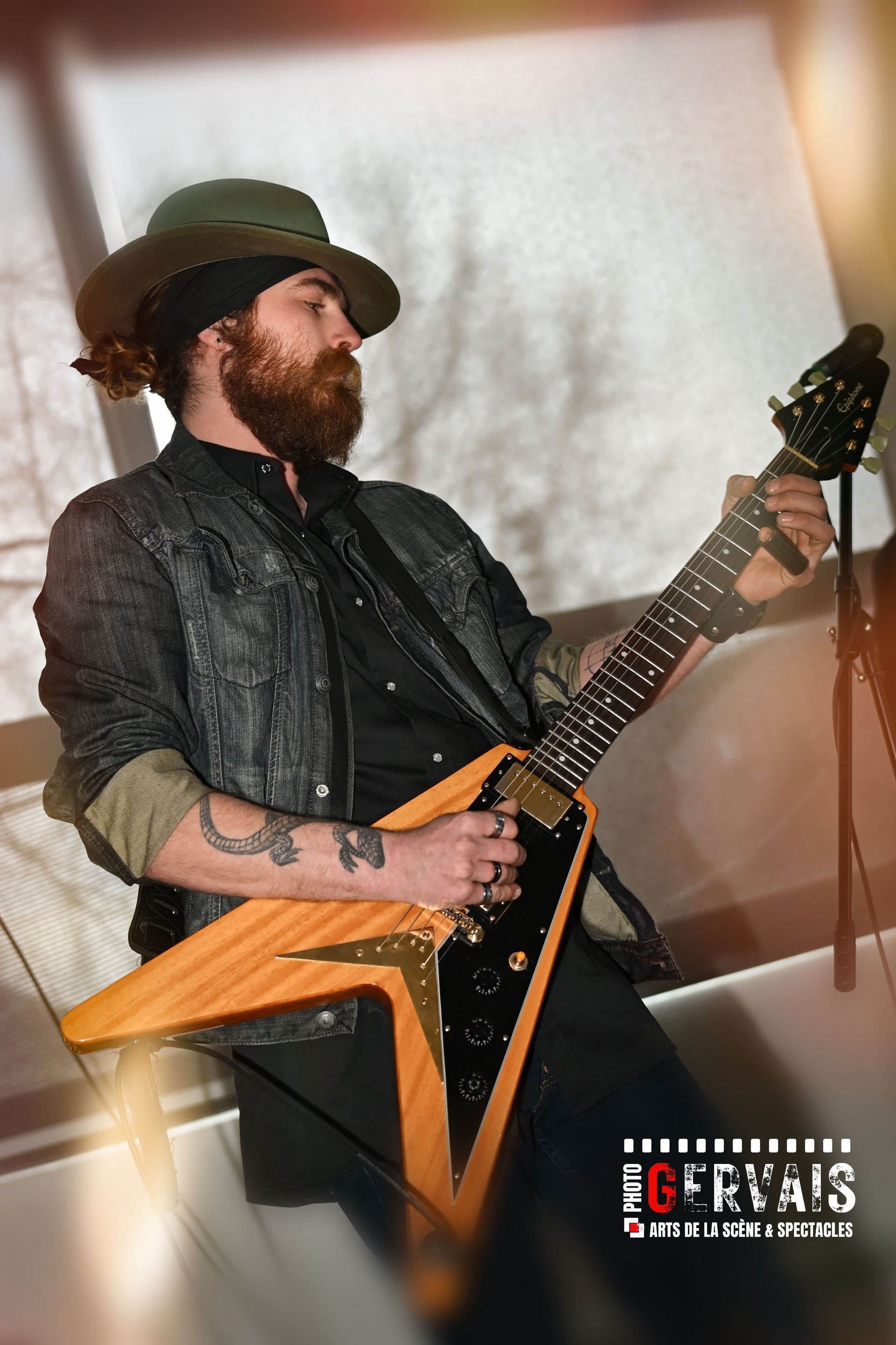 A woman dressed in black holding a shaker and singing