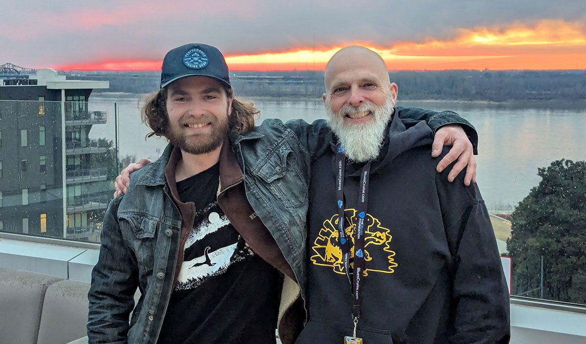 Father'n'Son posing on the rooftop of the hotel with a sunset on the Mississippi River