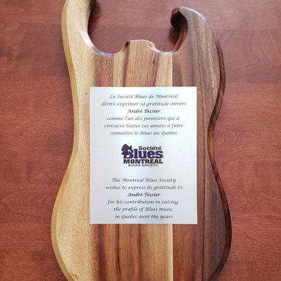 Guitar-shaped plaque honoring André Tessier for promoting Blues music in Quebec.