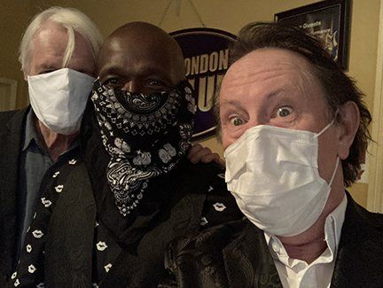 Jack DeKeyzer with a couple of band members wearing PPE