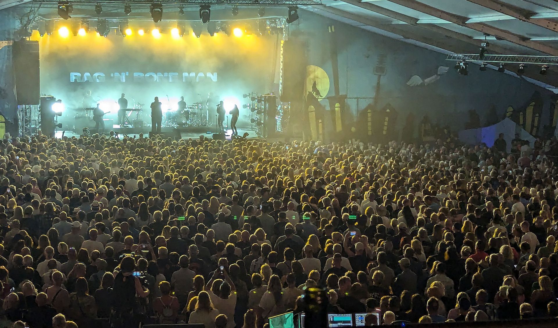 Rag'n'Bone Man on stage with many hundreds of people in the audience