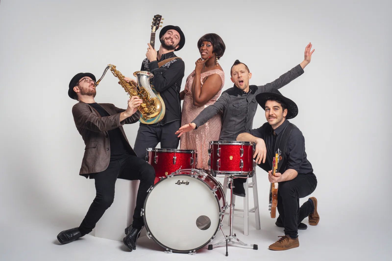 Photo of the Sugar Darlings, may contain a saxophone, drums, a woman and four men
